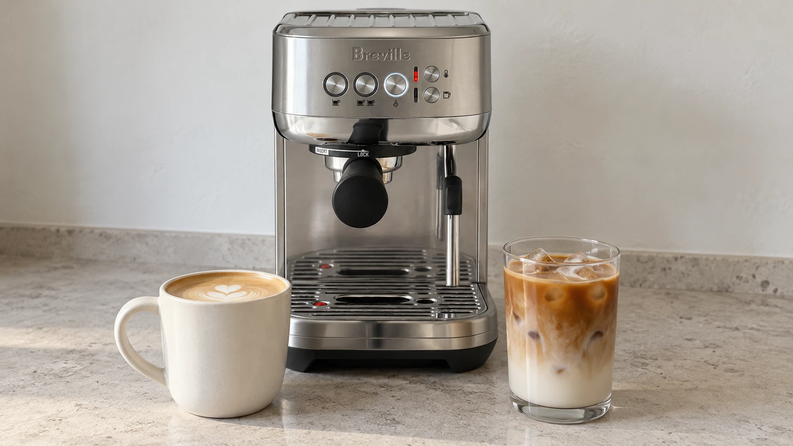 Hot latte and iced latte next to a home espresso machine